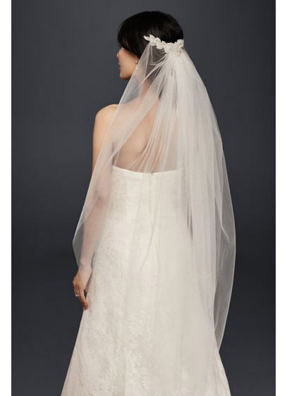 Every bride deserves to feel like a princess on her big day. Channel 1950’s icon and real life princess Grace Kelly with a veil that skims just below the elbows, like this one from David’s Bridal.
