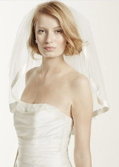 For all the playful brides who plan on spending most of the night on the dance floor, opt for a playful shoulder length veil that gives you the freedom to move in. This one from David’s Bridal is a perfect example.
