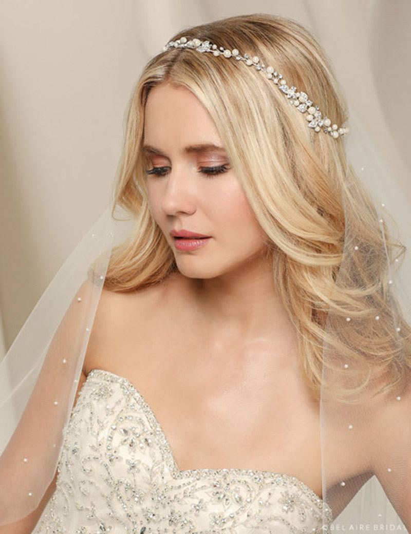 Don a lovely vine of soft pearls and twinkling rhinestone leaves. This gorgeous garland is secured with easy-wear satin ties. Bel Aire Bridal Style 6534, $149, Claire’s Fashions, Wilmington, Del. 